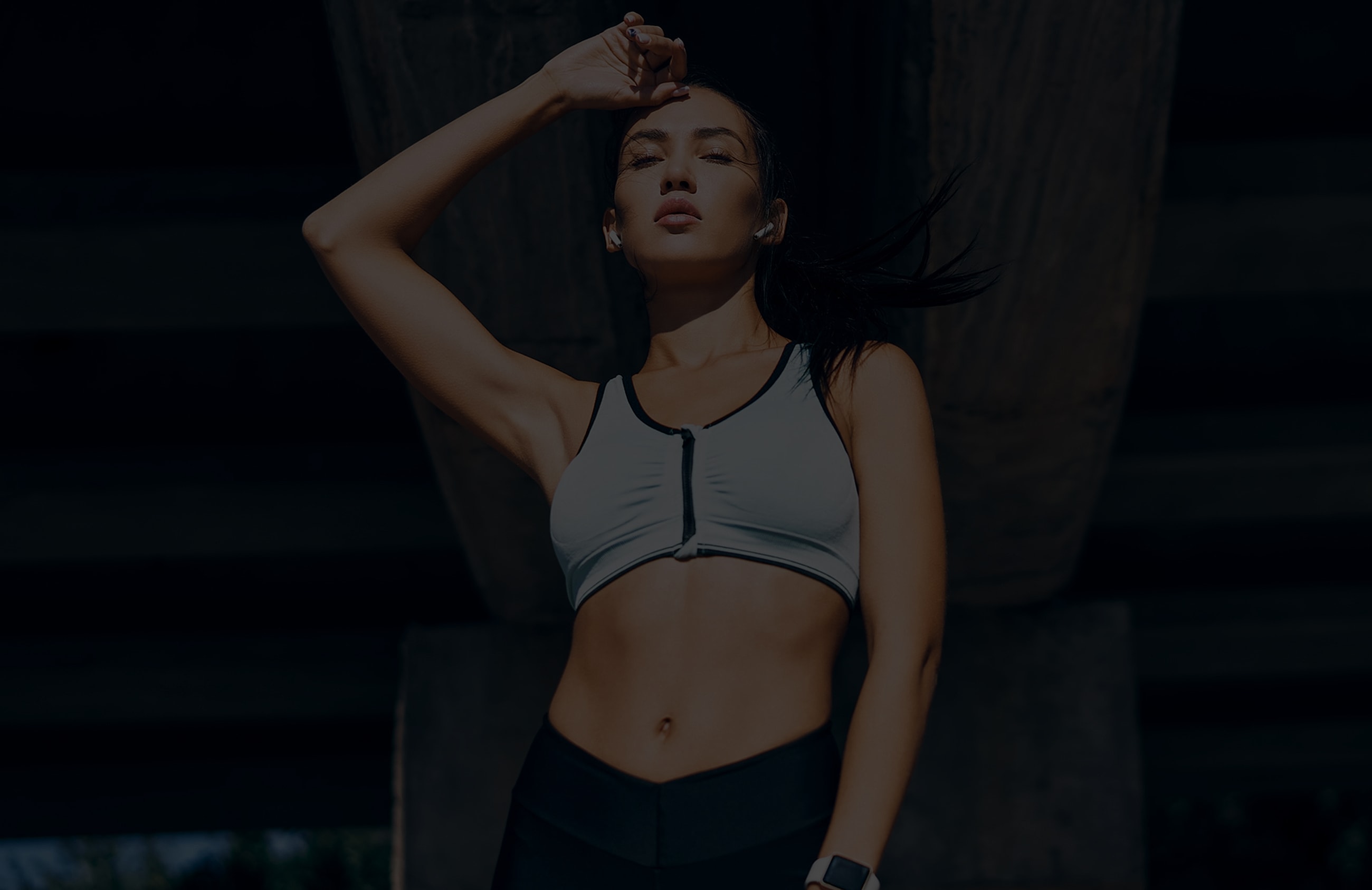 Athletic woman posing confidently outdoors.