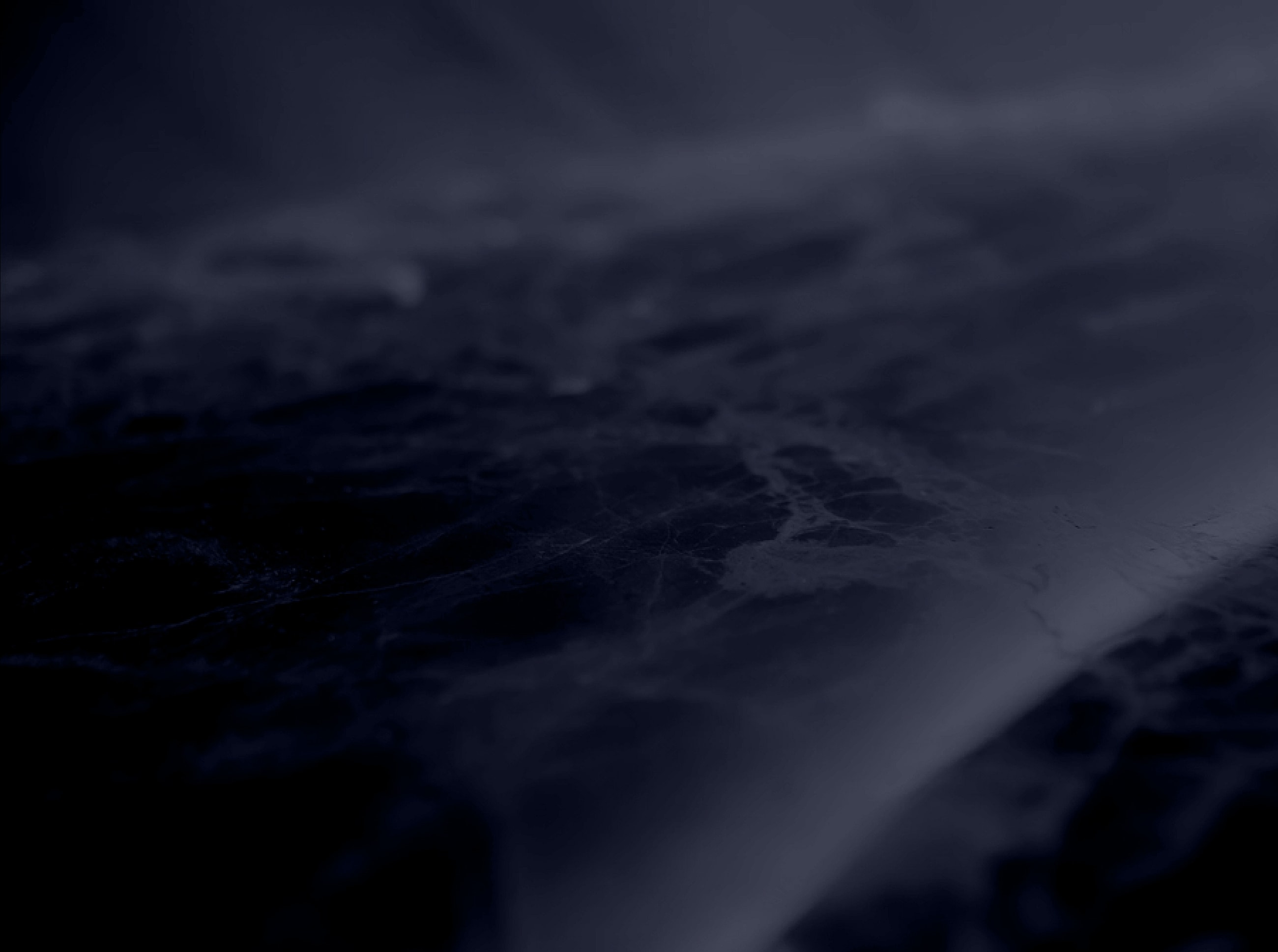 Dark textured surface with abstract patterns.