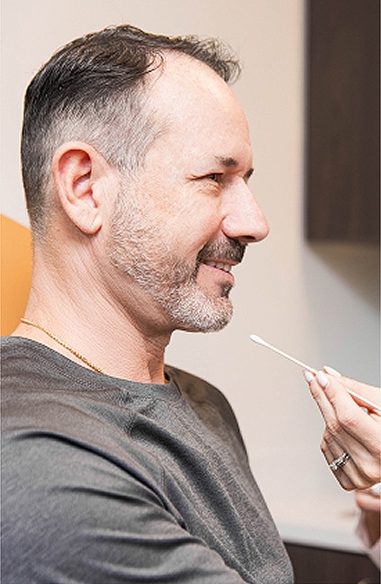Man smiling during a beauty treatment session.