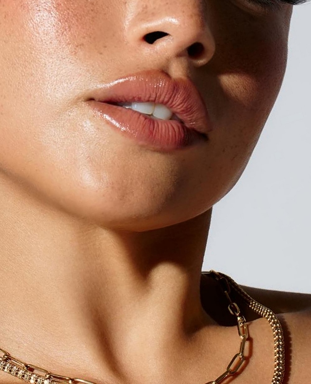 Close-up of lips and neck with jewelry