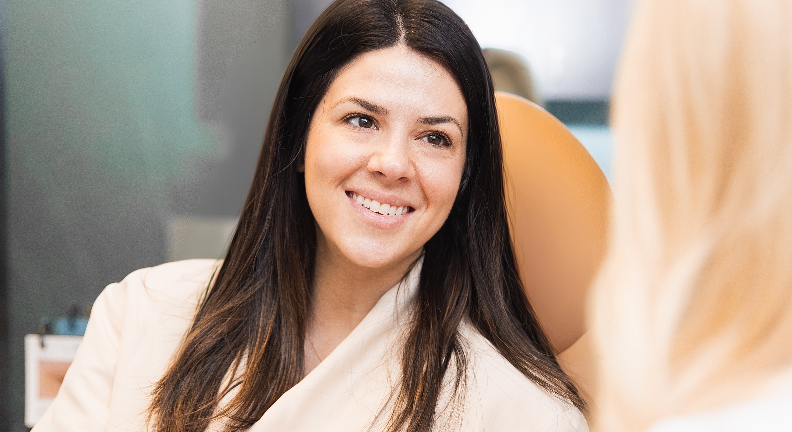 Smiling woman in a consultation setting.