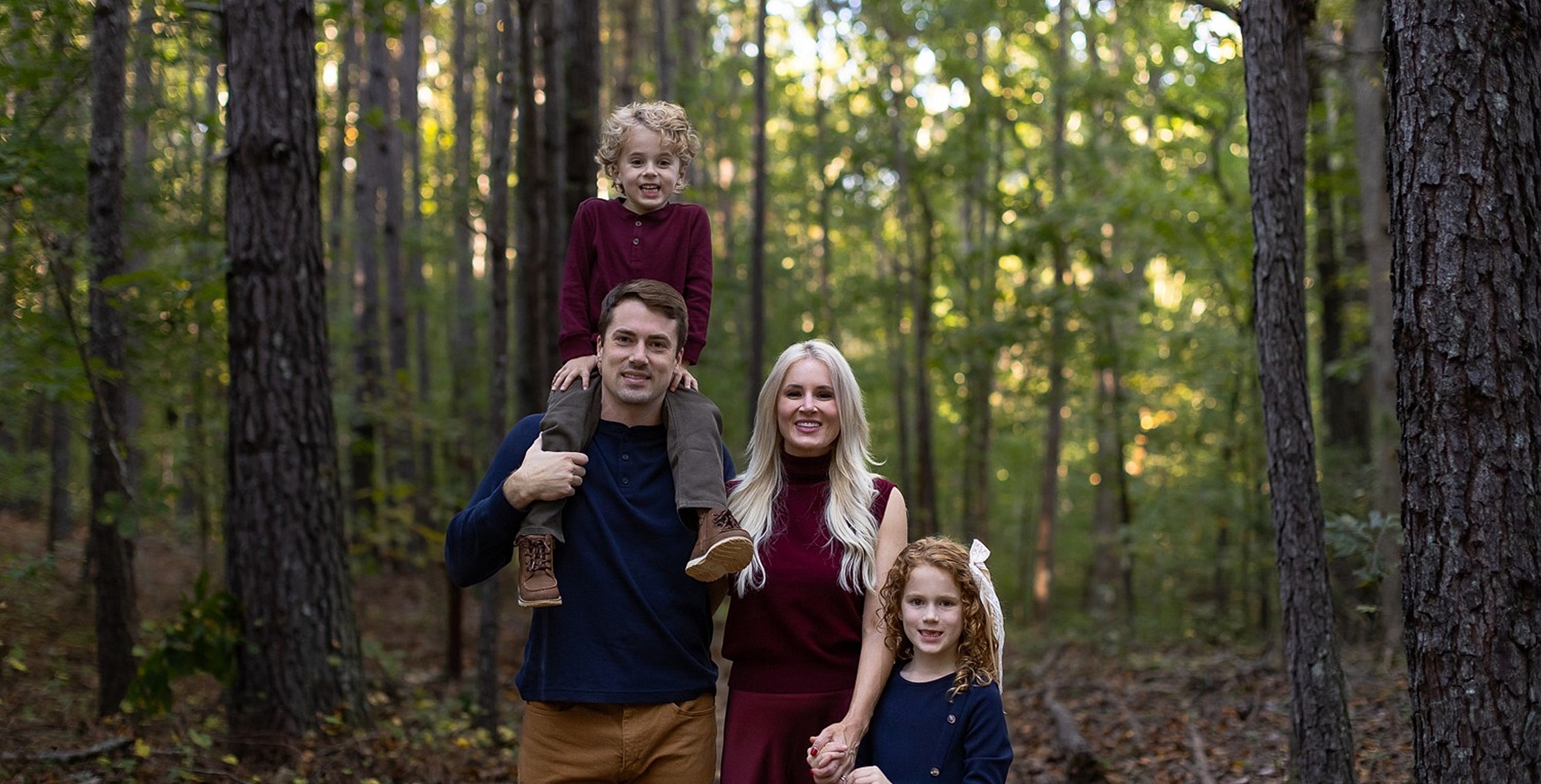 Family portrait in a forest setting.