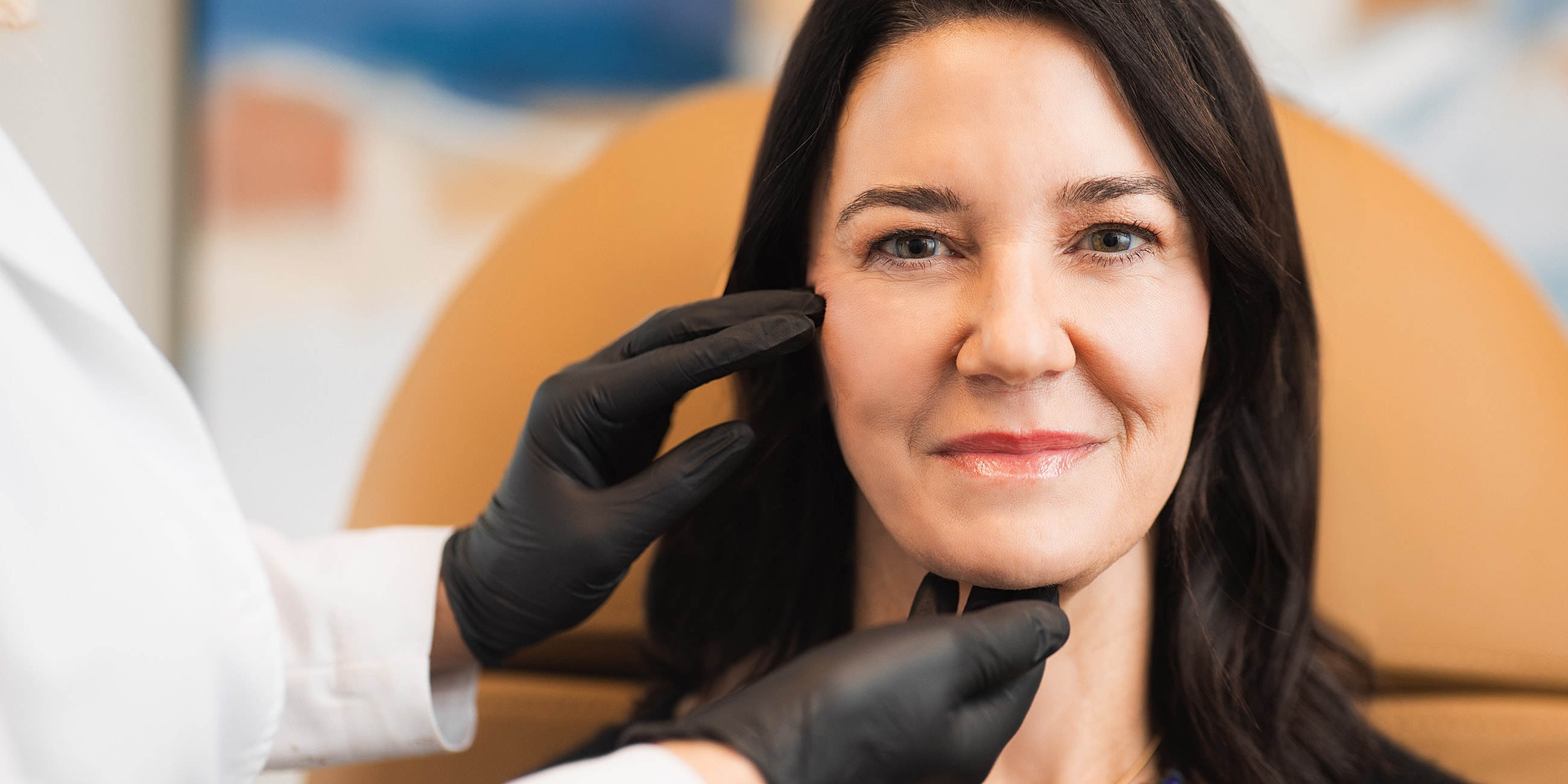 Patient receiving skincare treatment in clinic.