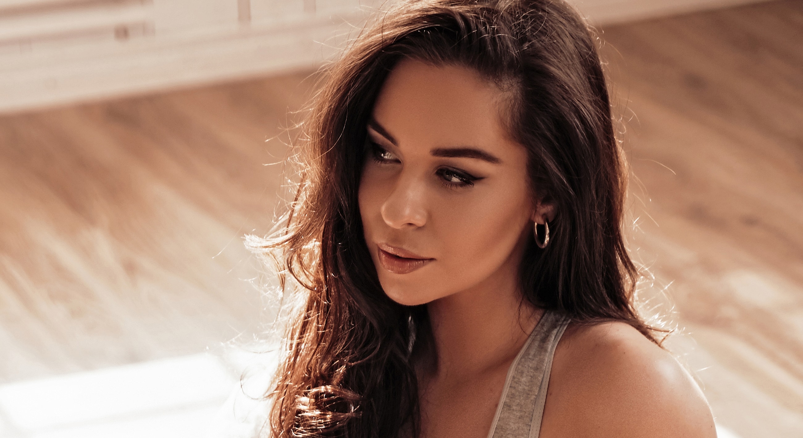 Woman with long hair in soft lighting.