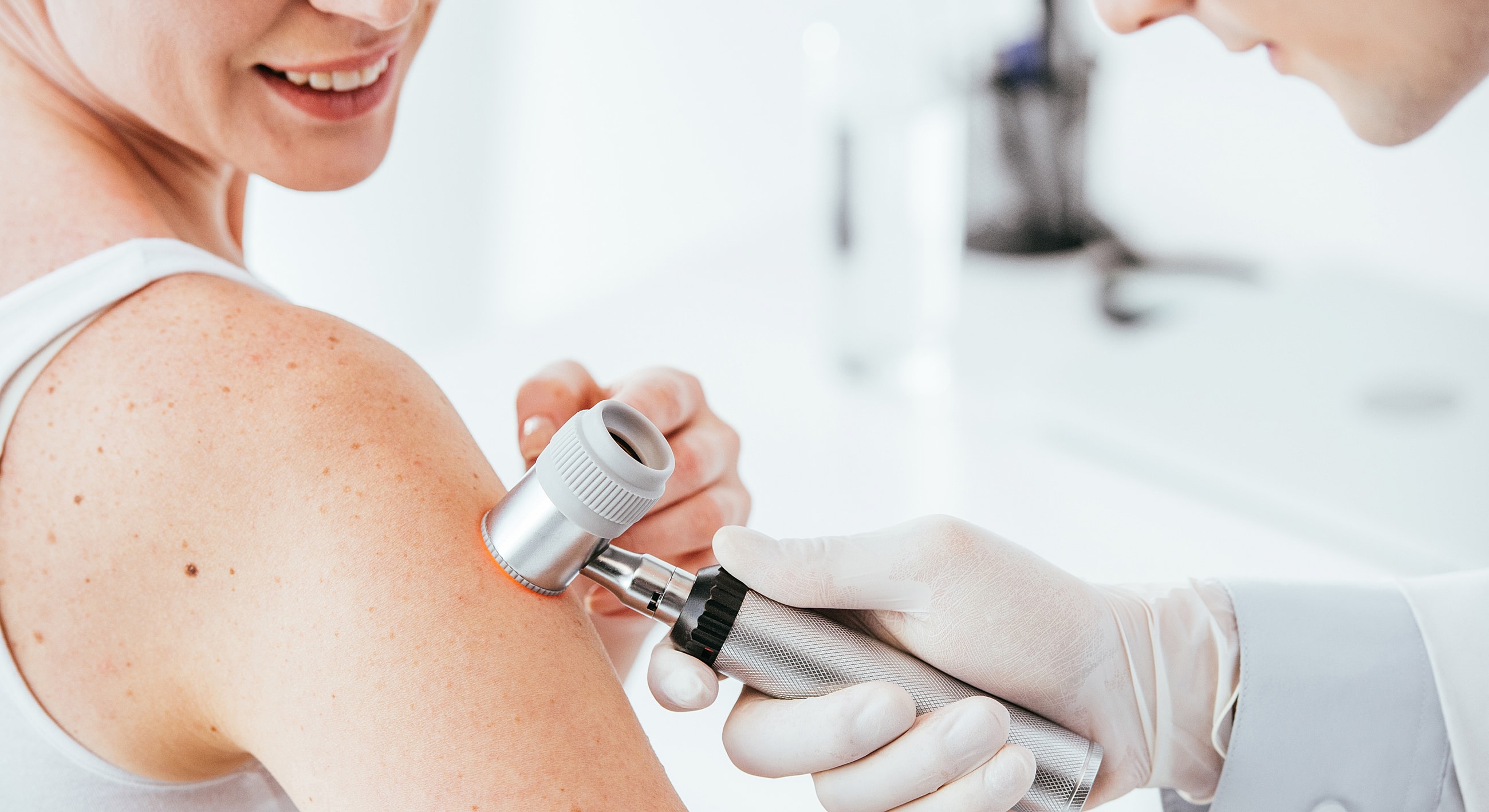 Dermatologist examining a patient's skin condition.
